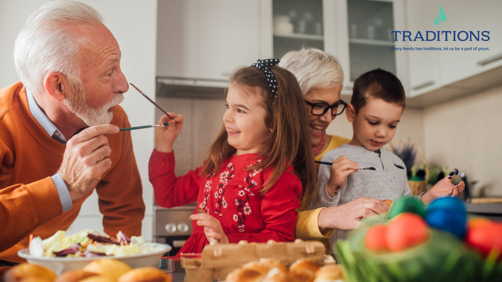 Two elderly people are painting and playing with their grandkids