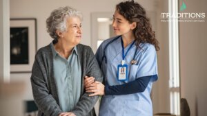 A senior woman smiling and looking at her female caregiver